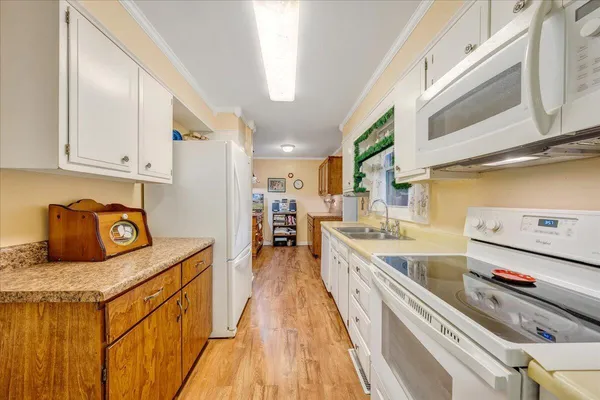 a kitchen with stainless steel appliances granite countertop a sink and cabinets
