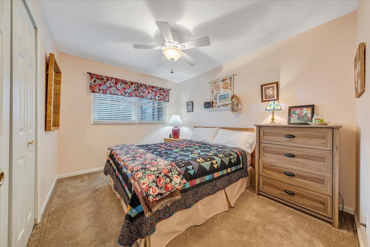 9009 Poor Mountain Road Bent Mountain, VA 24059 - Photo 18 of 30 a bedroom with a bed and a chandelier