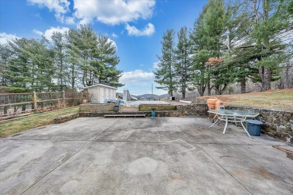 a view of backyard with outdoor seating and trees