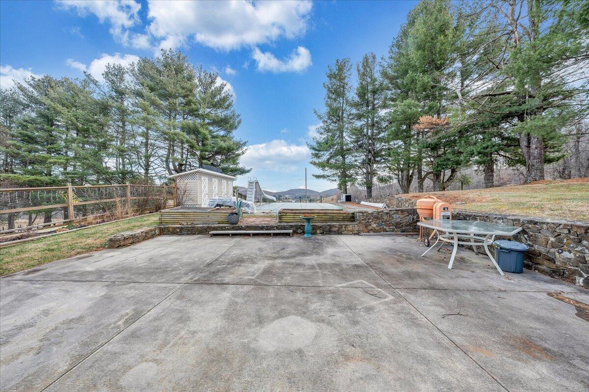 9009 Poor Mountain Road Bent Mountain, VA 24059 - Photo 22 of 30 a view of backyard with outdoor seating and trees