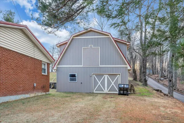 a view of a house with a yard and garage