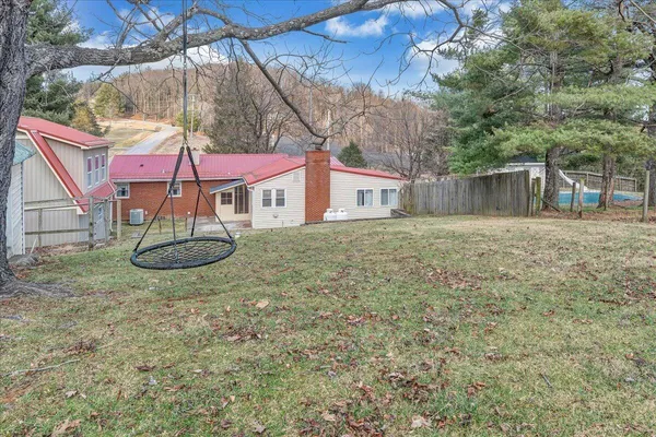 a view of a backyard with table and chairs under an umbrella