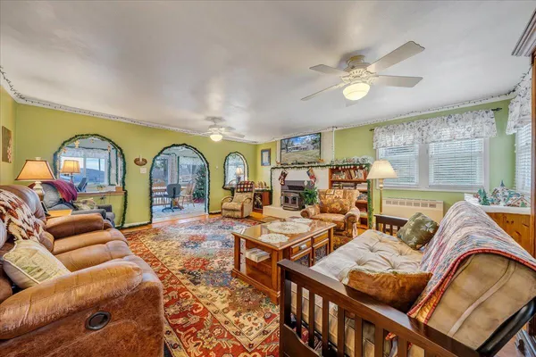 a living room with furniture a fireplace and a chandelier