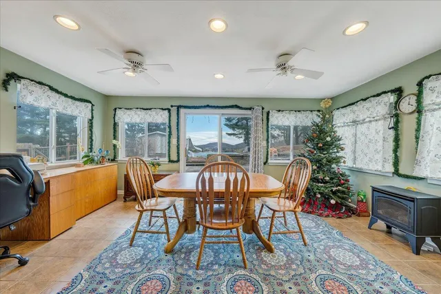 a dining room with furniture a rug and a chandelier