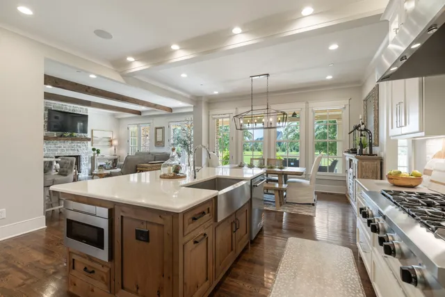 a kitchen with stainless steel appliances granite countertop a stove and a large window