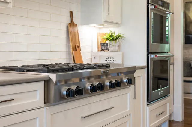 a kitchen with stainless steel appliances a stove and a refrigerator