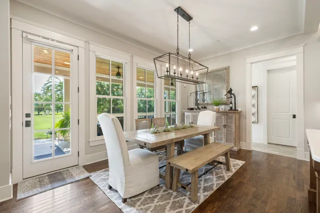 a view of a dining room with furniture wooden floor and chandelier