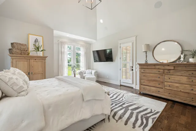 a en suite bathroom with a granite countertop sink mirror and bathtub