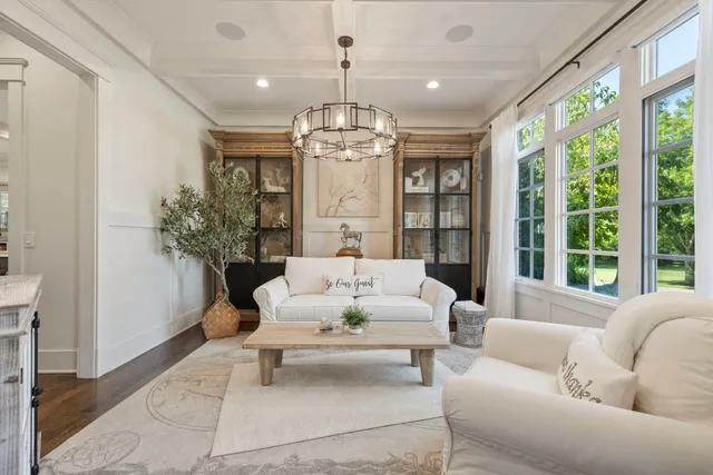 a living room with furniture and a chandelier