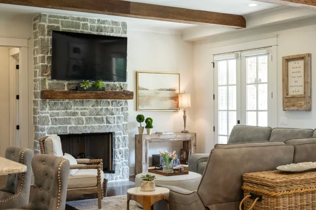 a living room with furniture a flat screen tv and a fireplace