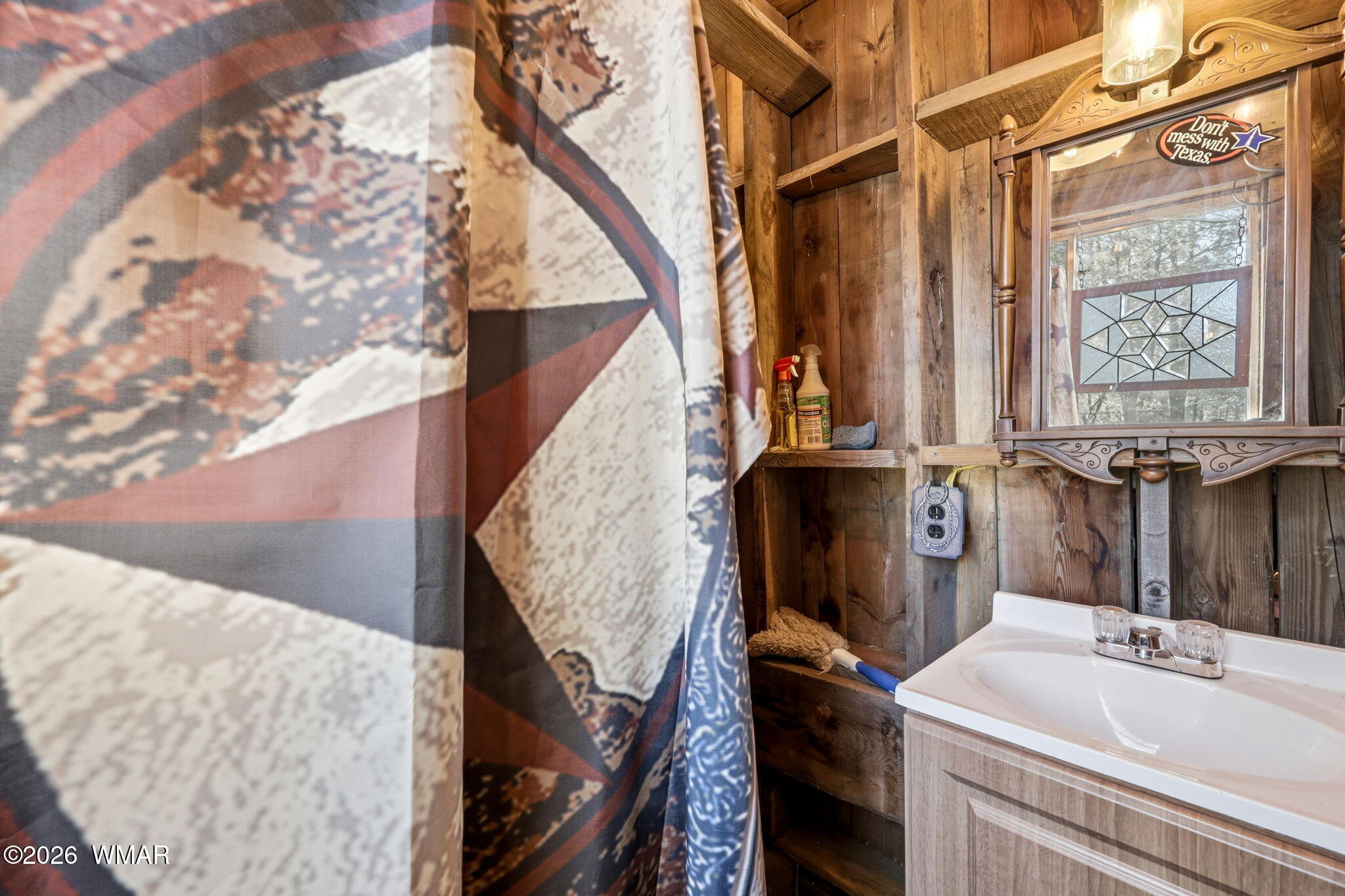 6480 Lower Ridge Drive Lakeside, AZ 85929 - Photo 23 of 32 a bathroom with a sink and a mirror