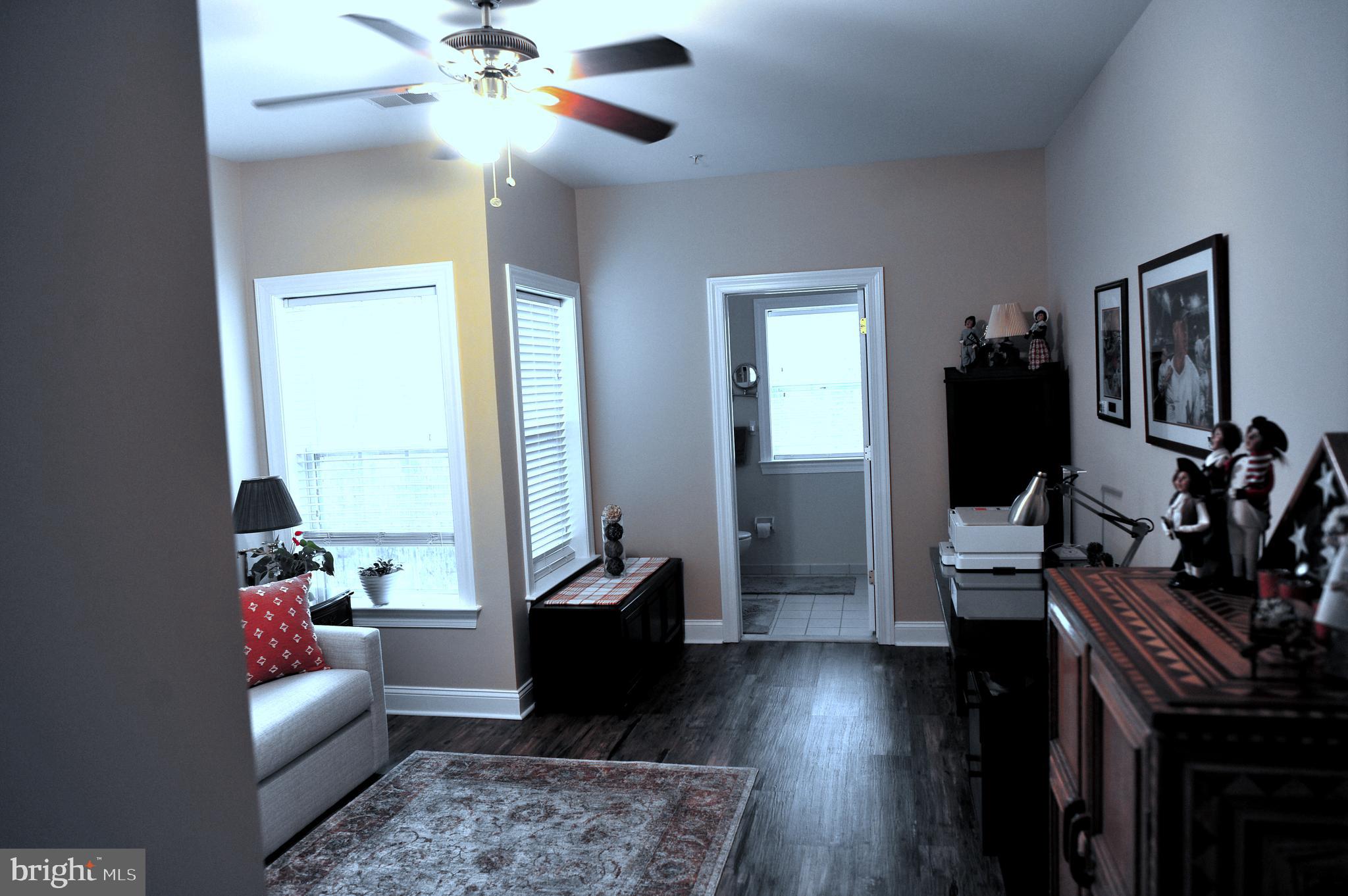 4000 Village Way, Unit 202 Boothwyn, PA 19061 - Photo 11 of 15 a living room with furniture and a wooden floor
