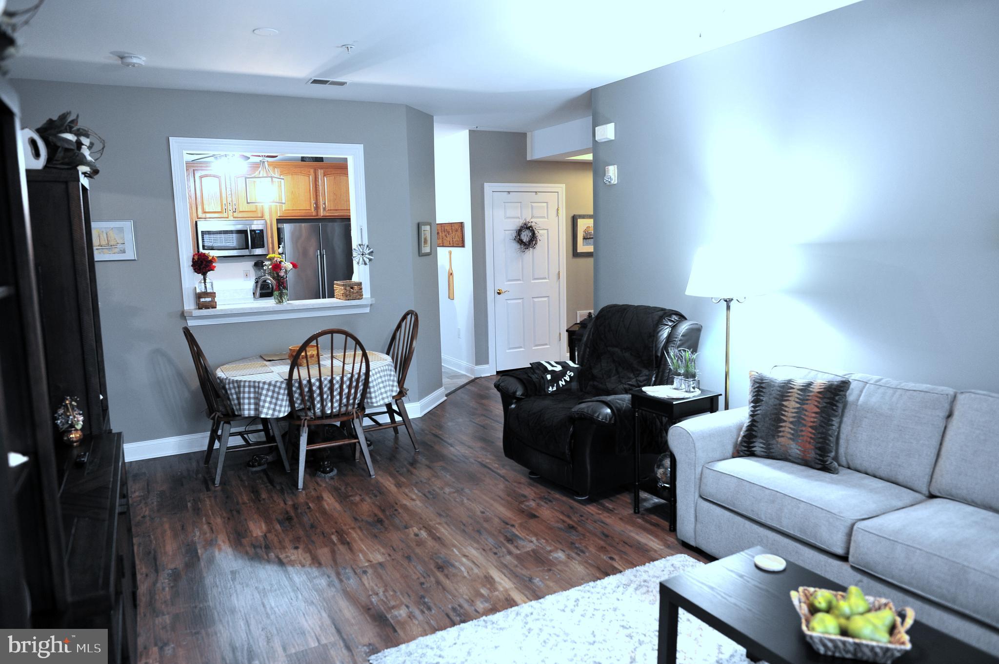 4000 Village Way, Unit 202 Boothwyn, PA 19061 - Photo 2 of 15 a living room with furniture and wooden floor
