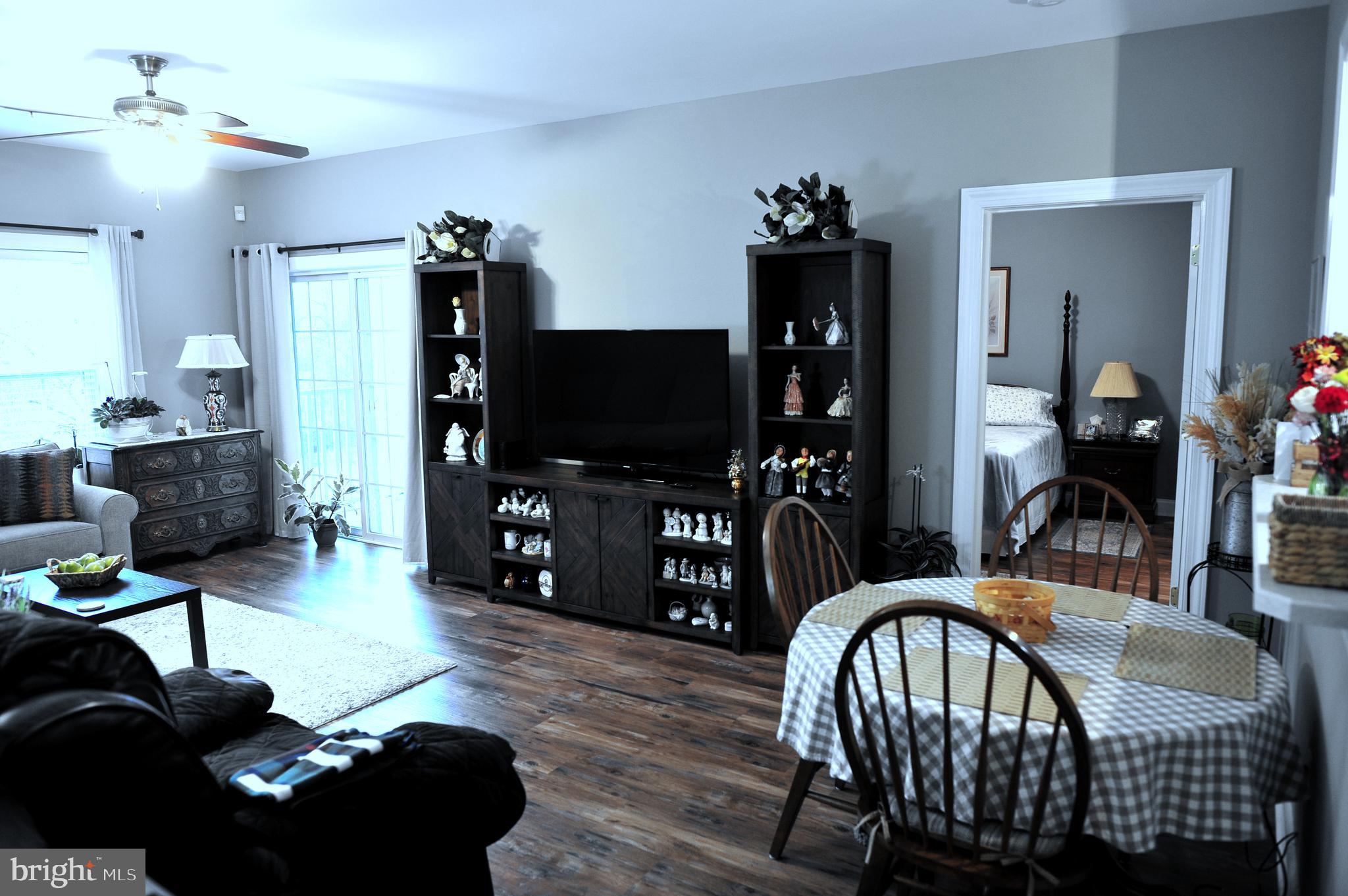 4000 Village Way, Unit 202 Boothwyn, PA 19061 - Photo 3 of 15 a living room with furniture and a flat screen tv