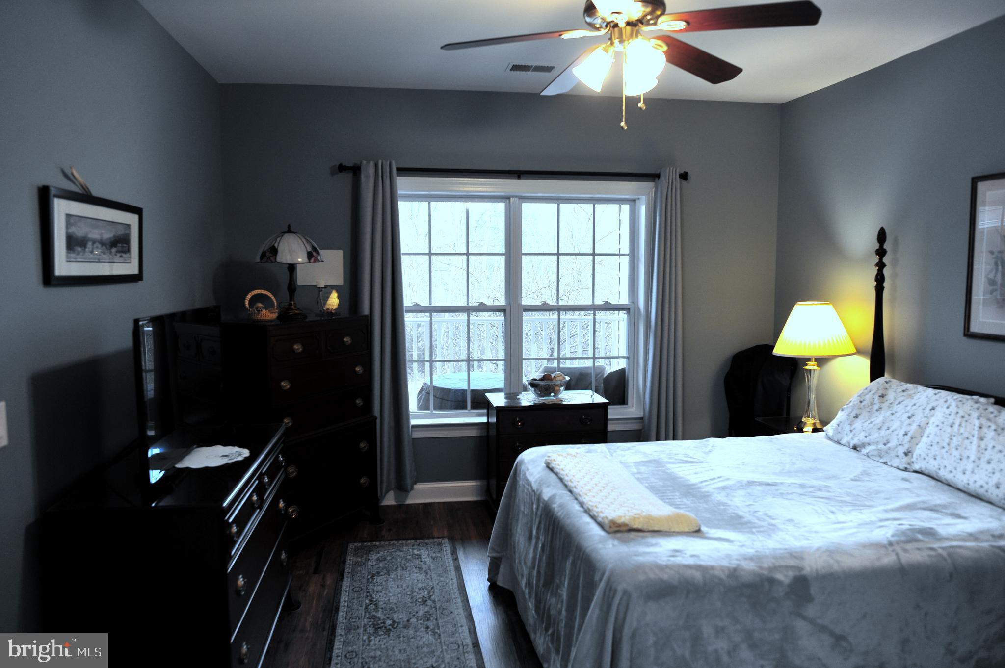4000 Village Way, Unit 202 Boothwyn, PA 19061 - Photo 6 of 15 a bedroom with a bed and a chandelier
