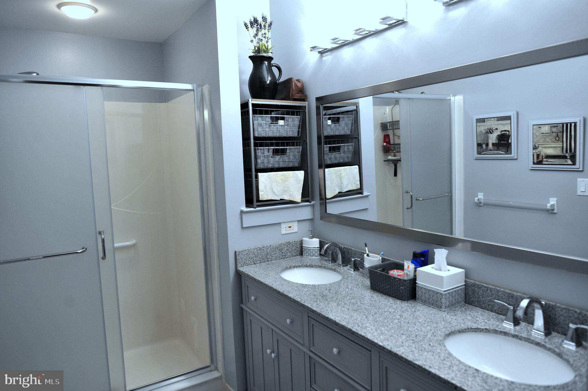 4000 Village Way, Unit 202 Boothwyn, PA 19061 - Photo 7 of 15 a bathroom with a granite countertop shower sink and mirror