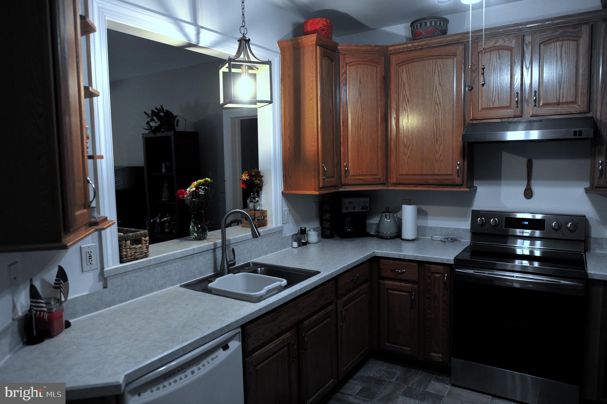 4000 Village Way, Unit 202 Boothwyn, PA 19061 - Photo 8 of 15 a kitchen with granite countertop a sink stainless steel appliances and cabinets