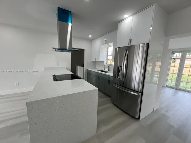 a front view of a house with a garden and trees