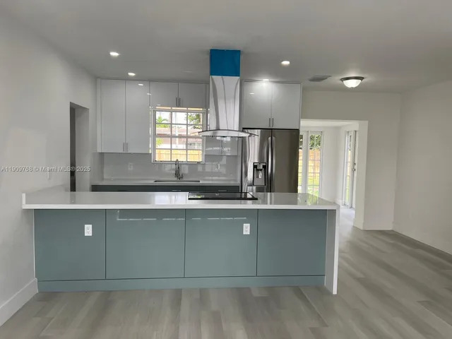 a kitchen with counter top space cabinets and appliances