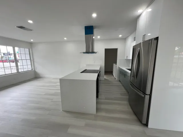 a front view of house with a garden