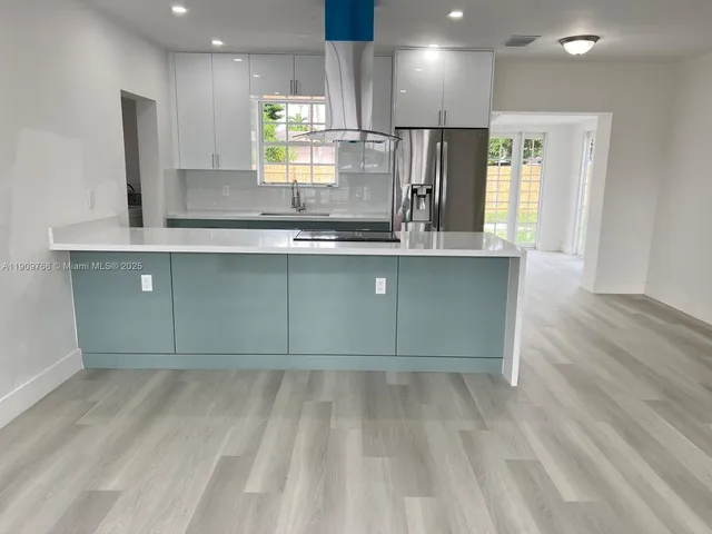 a kitchen with granite countertop a sink and cabinets