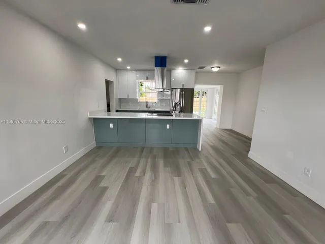 a white toilet sitting next to a bathroom sink and tub