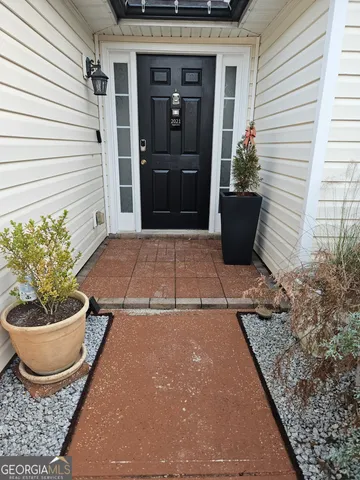 a view of a livingroom with wooden floor and a fireplace