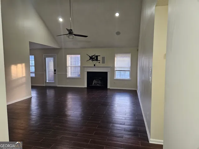 a view of a chandelier fan and wooden floor