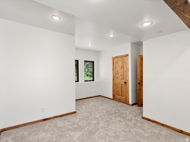 1225 Old Oregon Road Soda Springs, ID 83276 - Photo 25 of 67 Interior room with light-colored carpeting, white walls, and recessed lighting