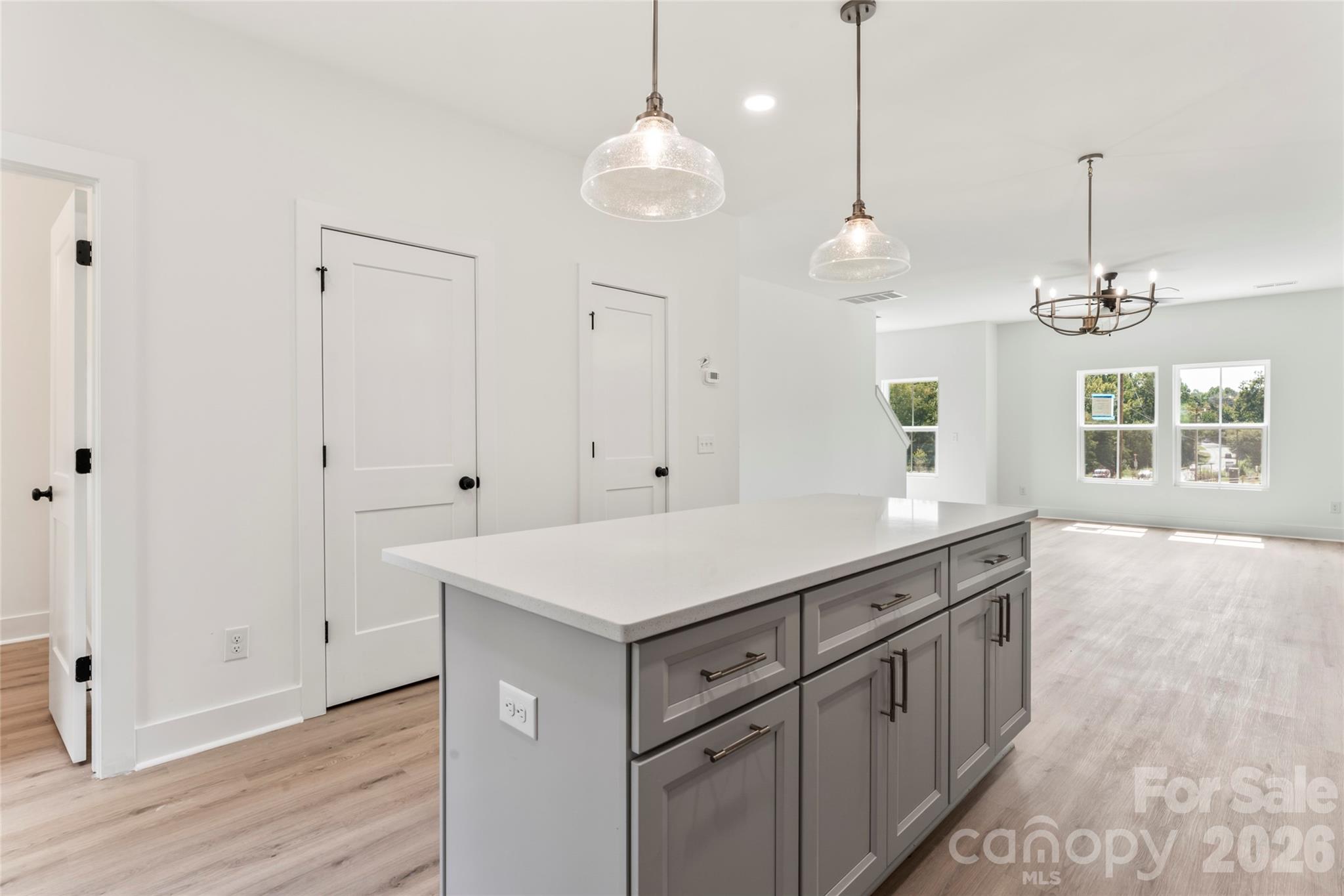 325 Yaupon Court, Unit 13 Fort Mill, SC 29708 - Photo 15 of 42 a kitchen with white cabinets and chandelier