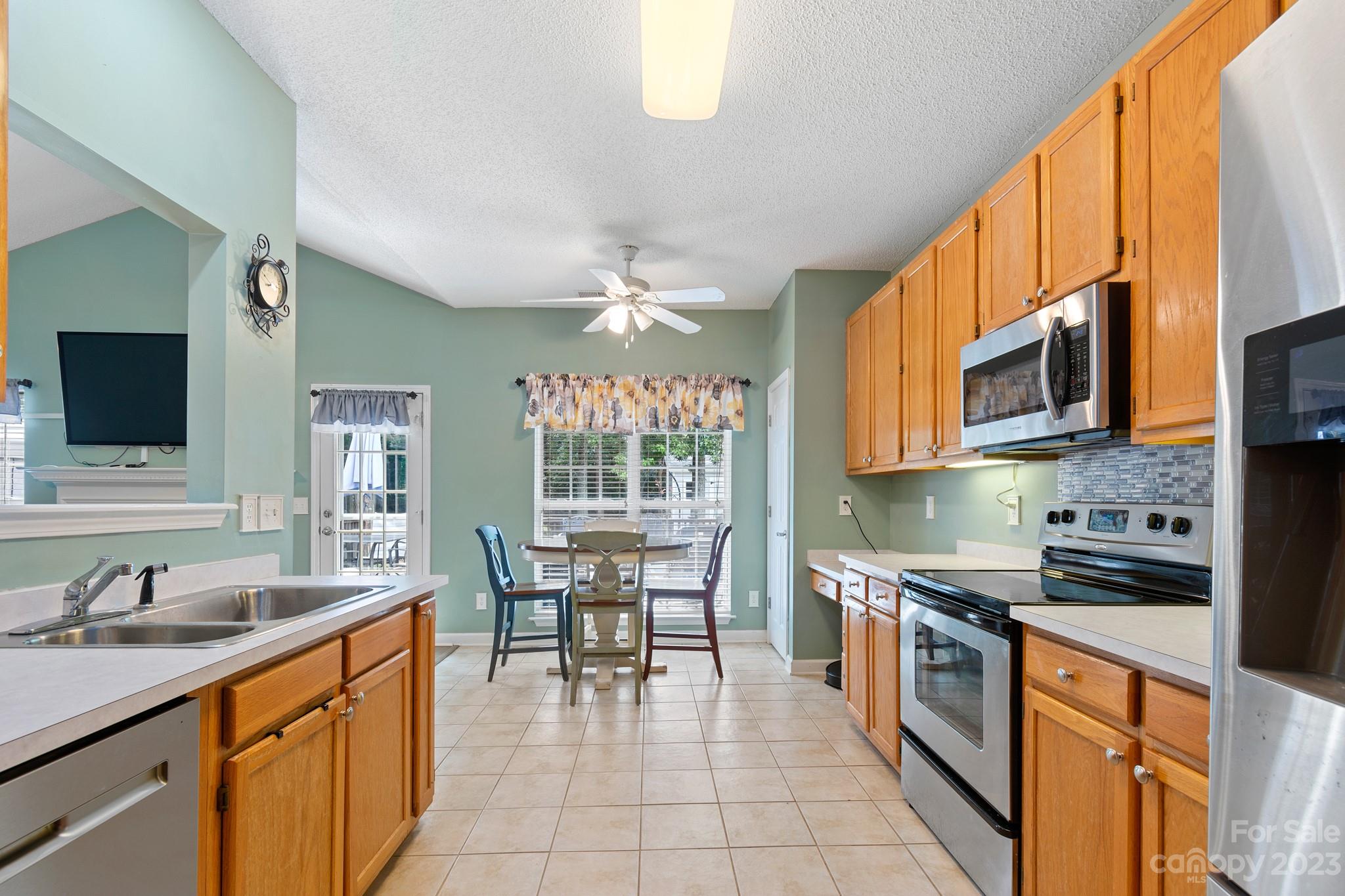 847 Knightsbridge Road Fort Mill, SC 29708 - Photo 13 of 27 a kitchen with stainless steel appliances kitchen island granite countertop a sink and cabinets