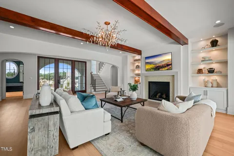 a living room with furniture potted plant and a large mirror