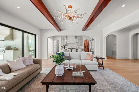 a kitchen with kitchen island a stove a table and chairs in it