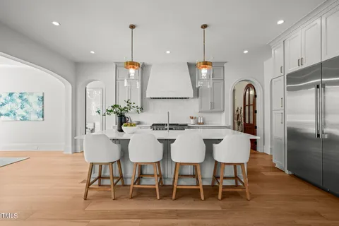 a kitchen with stainless steel appliances a sink a stove top oven a counter space and cabinets