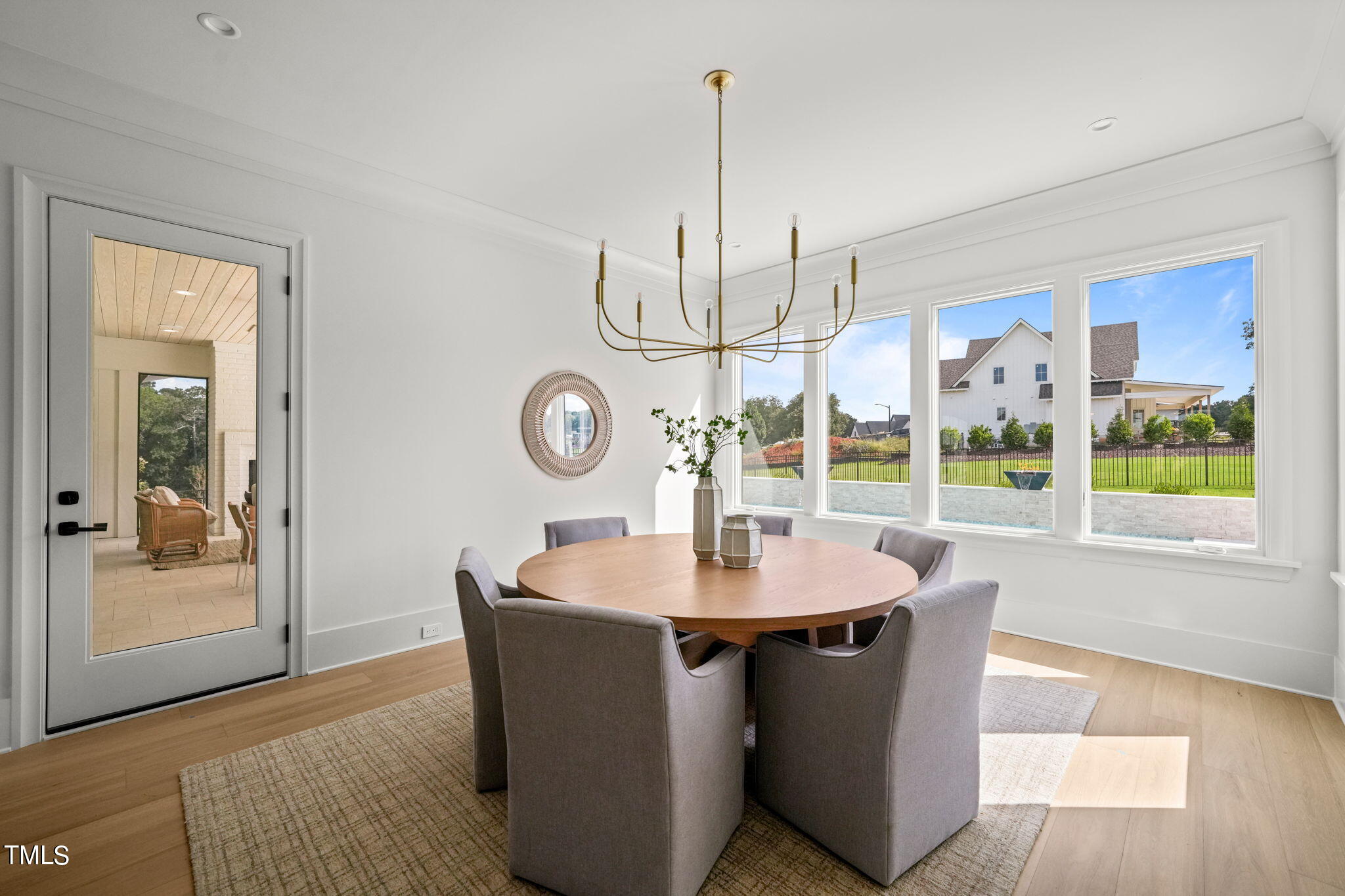 8916 Grand Highland Way Wake Forest, NC 27587 - Photo 17 of 80 a dining room with wooden floor a chandelier a wooden table and chairs