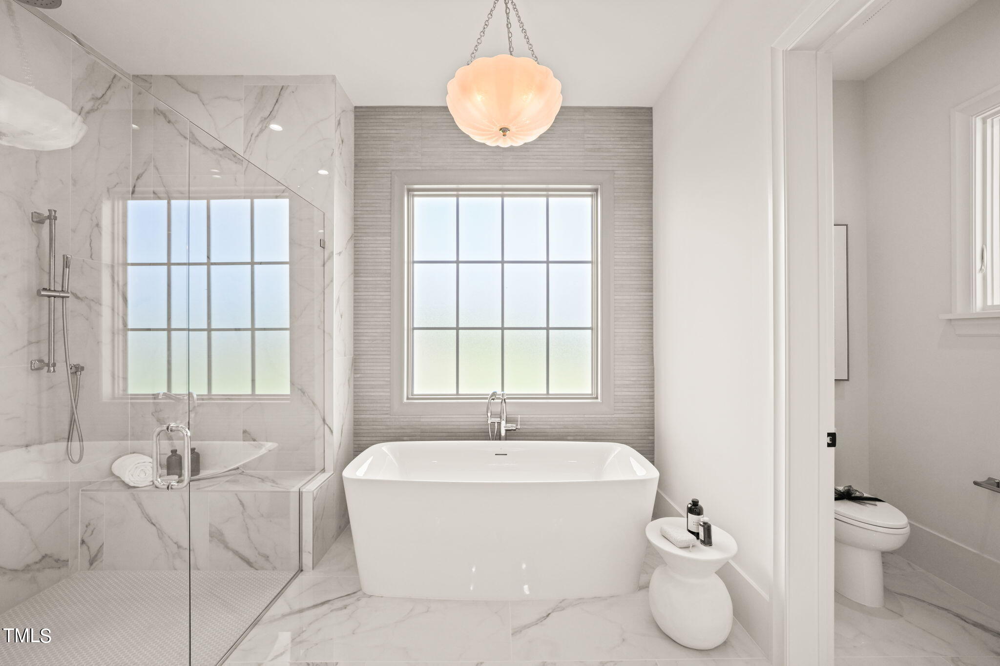 8916 Grand Highland Way Wake Forest, NC 27587 - Photo 27 of 80 a bathroom with a granite countertop sink toilet a large mirror and a window