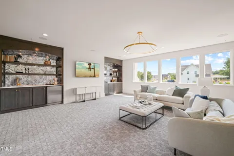 a living room with furniture a couch and a window