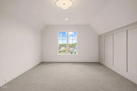 a dining room with furniture and a floor to ceiling window