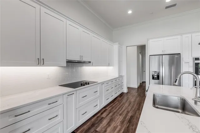 a bedroom with a bed and a flat tv screen on dresser