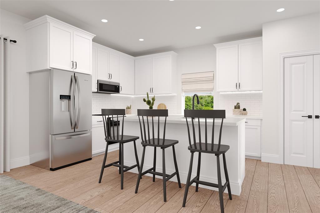 8712 Saratoga Street Pilot Point, TX 76258 - Photo 2 of 7 a kitchen with stainless steel appliances a dining table chairs refrigerator microwave and stove top oven