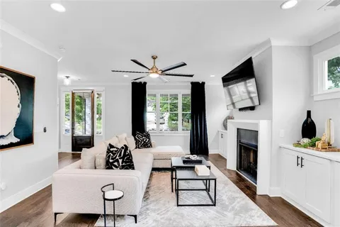 a living room with furniture a fireplace and a flat screen tv