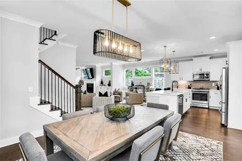 a kitchen with sink table and chairs