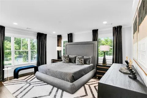 a bedroom with a bed and a large window