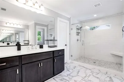a bathroom with a shower sink and mirror