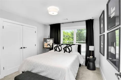 a bedroom with a large bed and a large window