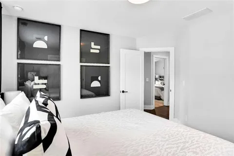 a bedroom with a bed and a mirror