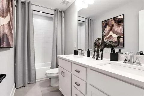 a bathroom with a toilet a sink and a mirror