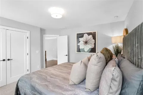 a bedroom with a large bed and a couch