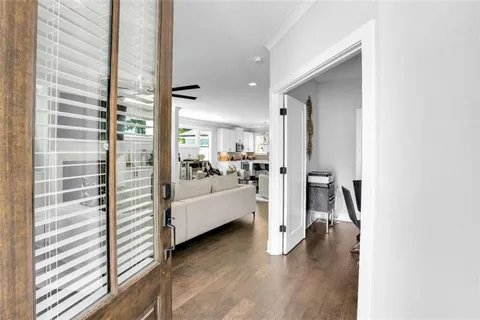 a view of living room with furniture and wooden floor