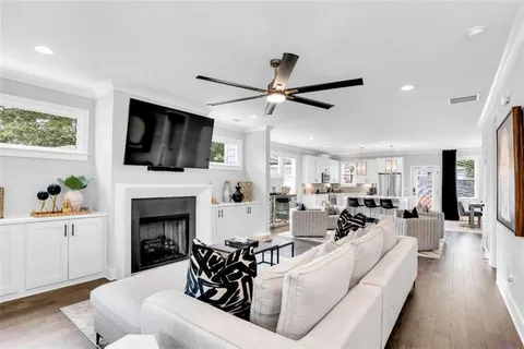 a living room with furniture a fireplace and a flat screen tv
